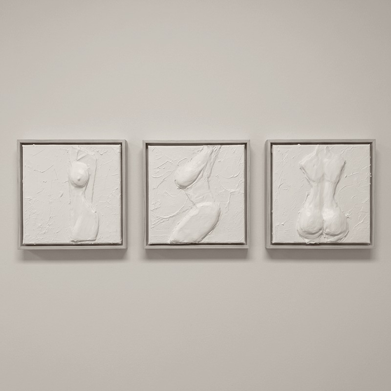 Three hand-sculpted body reliefs, framed